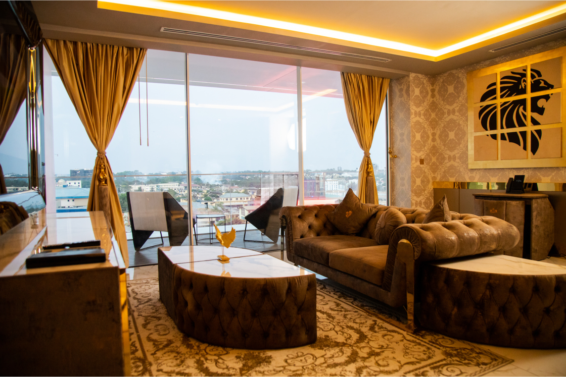 Living area with floor-to-ceiling windows, city-view, balcony and workspace